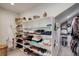 Organized walk-in closet with ample shelving for shoes and folded clothes, maximizing storage and accessibility at 11904 W Auburn Dr, Denver, CO 80228