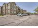 Apartment building featuring stone accents, multiple stories, and ample parking at 9185 Wilde Ln # 301, Parker, CO 80134