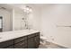 Modern bathroom featuring a large mirror over the vanity, a shower with glass door, and a toilet at 9185 Wilde Ln # 301, Parker, CO 80134