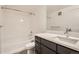 A clean bathroom with a shower-tub combination and modern vanity with gray cabinets at 9185 Wilde Ln # 301, Parker, CO 80134