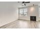 Bright bedroom with a large window, fireplace, and light wood floors at 9185 Wilde Ln # 301, Parker, CO 80134