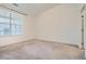 Neutral bedroom featuring plush carpeting, bright natural light from a large window, and modern finishes at 9185 Wilde Ln # 301, Parker, CO 80134