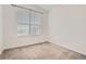 Neutral bedroom featuring a bright window with white walls and neutral carpet at 9185 Wilde Ln # 301, Parker, CO 80134