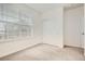 Bright bedroom with large window and closet featuring neutral carpet and white walls at 9185 Wilde Ln # 301, Parker, CO 80134