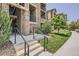 Building entrance featuring stairs, landscaping, and visible unit numbers at 9185 Wilde Ln # 301, Parker, CO 80134