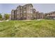 A sprawling lawn outside the apartments, lush with green grass and new landscaping at 9185 Wilde Ln # 301, Parker, CO 80134