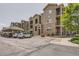 Apartment building displaying stone and siding exterior, covered parking and patios at 9185 Wilde Ln # 301, Parker, CO 80134