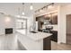 Modern kitchen features stainless appliances, a large island, and open living space at 9185 Wilde Ln # 301, Parker, CO 80134