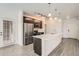Modern kitchen features stainless steel appliances, dark cabinets, and a large island with white countertops at 9185 Wilde Ln # 301, Parker, CO 80134