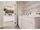 Laundry room with modern appliances and open shelving; door to the kitchen at 9185 Wilde Ln # 301, Parker, CO 80134
