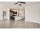Open-concept living space with a kitchen, fireplace, and modern design elements at 9185 Wilde Ln # 301, Parker, CO 80134