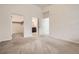 Spacious bedroom featuring plush carpet, an open closet, and access to the bathroom and closet at 9185 Wilde Ln # 301, Parker, CO 80134