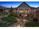 Beautiful backyard with covered patio, hot tub and tiered landscaping with water feature at 10687 Featherwalk Way, Highlands Ranch, CO 80126
