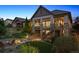 Outdoor space featuring landscaped backyard with fire pit, and covered deck with stairway at 10687 Featherwalk Way, Highlands Ranch, CO 80126