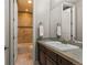 Bathroom featuring a bath, a walk-in shower, a single sink and neutral tiles at 10687 Featherwalk Way, Highlands Ranch, CO 80126
