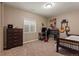 Bedroom featuring a music area, a window with natural light, and neutral paint colors at 10687 Featherwalk Way, Highlands Ranch, CO 80126