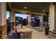 Relaxing covered patio with outdoor dining and heater enjoying neighborhood views at twilight at 10687 Featherwalk Way, Highlands Ranch, CO 80126