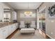Bright dining area with white cabinets, granite countertops, elegant chandelier, and sliding door access to the outside at 10687 Featherwalk Way, Highlands Ranch, CO 80126