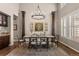 Charming dining room featuring decorative pillars, chandelier, and elegant window shutters at 10687 Featherwalk Way, Highlands Ranch, CO 80126