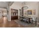Elegant dining room with wood floors, chandelier, and adjacent wine bar at 10687 Featherwalk Way, Highlands Ranch, CO 80126