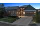 Attractive home featuring stone accents, three-car garage, complemented by a landscaped yard at 10687 Featherwalk Way, Highlands Ranch, CO 80126