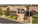 Beautiful home featuring stone accents, three-car garage, and meticulously landscaped front yard at 10687 Featherwalk Way, Highlands Ranch, CO 80126