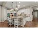 Kitchen island with granite countertops, pendant lighting, stainless steel appliances, and a tile backsplash at 10687 Featherwalk Way, Highlands Ranch, CO 80126