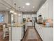 Modern kitchen featuring white cabinets, stainless steel appliances, granite countertops, and hardwood floors at 10687 Featherwalk Way, Highlands Ranch, CO 80126