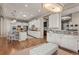 Spacious kitchen with white cabinets, granite countertops, stainless steel appliances, and an island with bar seating at 10687 Featherwalk Way, Highlands Ranch, CO 80126