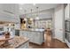 Kitchen island boasts granite countertops, stainless steel appliances, and hardwood flooring with open concept to Gathering room at 10687 Featherwalk Way, Highlands Ranch, CO 80126