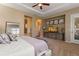 Spacious main bedroom featuring a ceiling fan, TV, neutral colors and an ensuite bathroom at 10687 Featherwalk Way, Highlands Ranch, CO 80126