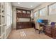 Bright office space with built-in shelves, dual monitors, and ample natural light at 10687 Featherwalk Way, Highlands Ranch, CO 80126