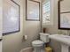 Stylish powder room with pedestal sink, framed art, and shuttered window at 10687 Featherwalk Way, Highlands Ranch, CO 80126
