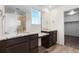 Elegant bathroom featuring dual sinks, granite countertops, a large mirror, and a glass-enclosed shower at 24325 E Ada Pl, Aurora, CO 80018