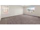 Bright bedroom featuring ample natural light from two windows and plush carpeting at 24325 E Ada Pl, Aurora, CO 80018