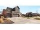 View of home exterior with large driveway and well manicured lawn at 24325 E Ada Pl, Aurora, CO 80018