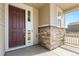 Welcoming front porch with stone accents, leading to the front door at 24325 E Ada Pl, Aurora, CO 80018
