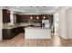 Open kitchen featuring dark wood cabinets, a large island, and wood flooring at 24325 E Ada Pl, Aurora, CO 80018