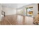 Bright living room with light-colored floors, large windows, and a sliding glass door to the backyard at 24325 E Ada Pl, Aurora, CO 80018