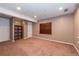 Finished basement area with storage and neutral carpet and paint at 12242 Bannock Cir # D, Denver, CO 80234