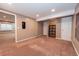 Open finished basement area with neutral colors, carpet, and storage solutions at 12242 Bannock Cir # D, Denver, CO 80234