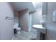 Cozy basement bathroom with pedestal sink, tiled floors, and shower at 12242 Bannock Cir # D, Denver, CO 80234