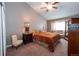 Comfortable bedroom with sloped ceilings, a ceiling fan and window seating at 12242 Bannock Cir # D, Denver, CO 80234