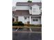 Inviting townhome with a charming front door adorned with a wreath and well-maintained landscaping at 12242 Bannock Cir # D, Denver, CO 80234
