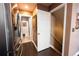 Hallway view offers access to bathroom, stainless steel refrigerator, and a staircase to another level at 12242 Bannock Cir # D, Denver, CO 80234