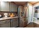 Modern kitchen featuring stainless steel refrigerator and a doorway to a bathroom at 12242 Bannock Cir # D, Denver, CO 80234