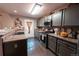 Stylish kitchen features gray cabinetry, stainless steel appliances, and ample counter space at 12242 Bannock Cir # D, Denver, CO 80234