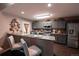Modern kitchen with gray cabinets, stainless steel appliances, and a breakfast bar with seating at 12242 Bannock Cir # D, Denver, CO 80234