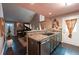 Open concept view from the kitchen to the fireplace and seating area at 12242 Bannock Cir # D, Denver, CO 80234