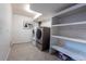 Basement laundry area featuring modern washer, dryer and shelving at 12242 Bannock Cir # D, Denver, CO 80234
